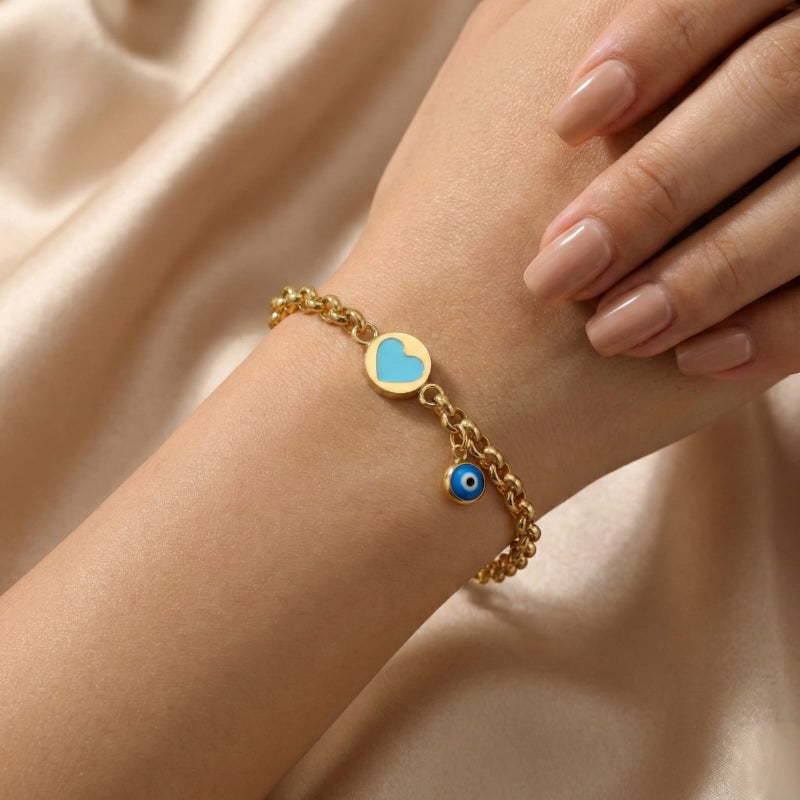 A gold-tone bracelet crafted from rust-resistant stainless steel, featuring a delicate turquoise heart design and a blue "eye" charm. Its modern design complements any look, and it has an adjustable clasp for a perfect fit. - Image 2